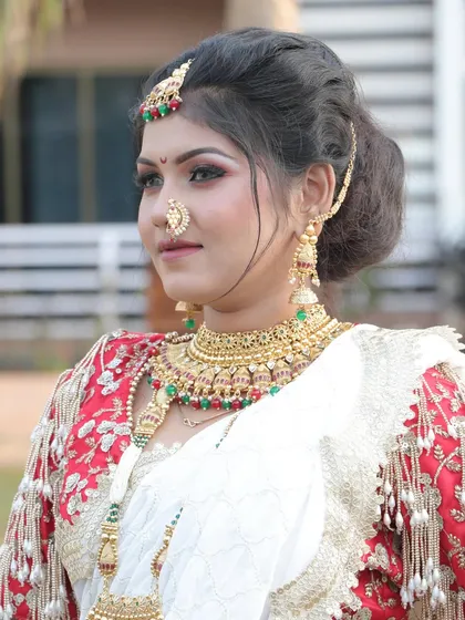 A close-up portrait showcasing the bride's elegant hair and makeup. The soft updo and defined features create a look of timeless beauty.