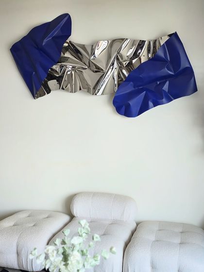 This piece was designed to be a bold focal point above the modern furniture, with the deep blue adding a striking pop of color.