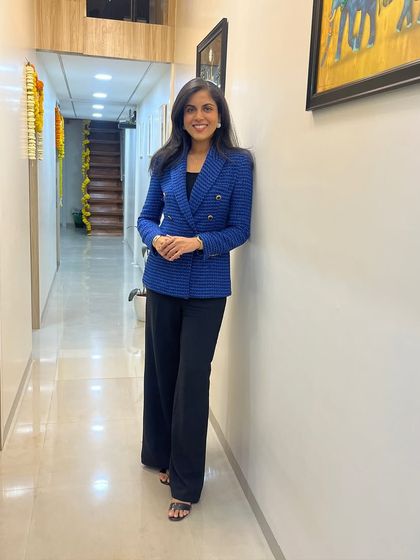 I am here to guide you on your journey to healthier skin. This photo was taken in the hallway of my clinic, a space I designed to be both professional and welcoming.