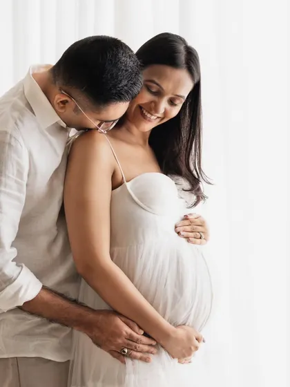 I live for capturing these quiet, tender moments between a couple. This close-up shot was taken in my studio with soft, natural-style lighting. Their simple white outfits and the gentle connection they share tell a beautiful story of love and anticipation.