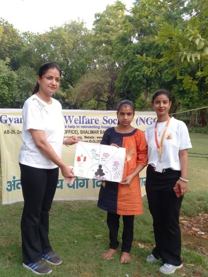 Presenting a certificate to a young participant for her beautiful drawing depicting the benefits of yoga. Encouraging creativity is also a part of holistic wellness.