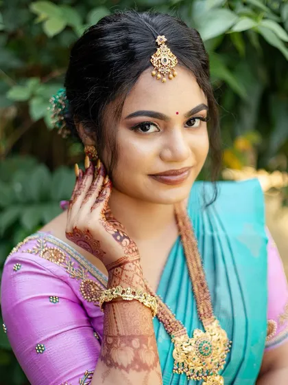 A beautiful close-up portrait of Sugirtha. Her makeup is perfectly balanced, with a focus on glowing skin and expressive eyes.