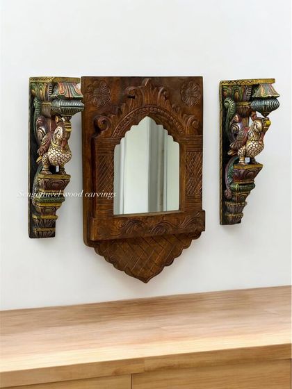 This set includes a wooden mirror frame with an arched design, flanked by two multicolored parrot brackets. It's a functional and highly decorative set for an entryway or bedroom.