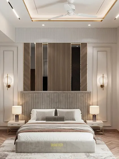 A master bedroom design for Apex D'Rio that fuses European and contemporary styles. The wall paneling features tinted mirrors and trim molding, while the opposite wall has a sleek TV unit and an integrated workstation.