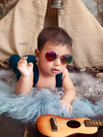 The coolest little rockstar in town, complete with sunglasses. This shot is full of personality and shows the fun side of our themed baby photoshoots.