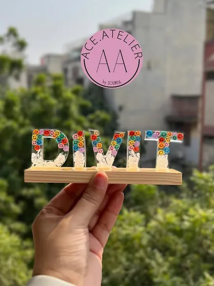 A playful and colorful name stand for 'Divit'. The bright flowers inside the letters make this a fun and personal gift for a child's desk or bedroom.