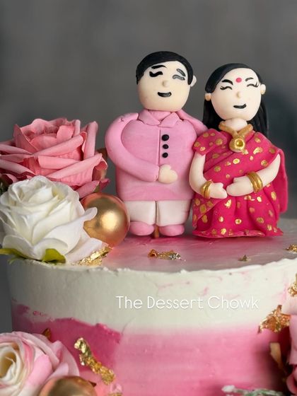 The custom fondant couple toppers in detail. I can create personalized figures to match your outfits and make your cake extra special.