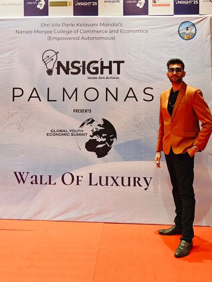 Standing proud at the 'Wall of Luxury' at the Global Youth Economic Summit. A powerful performance begins with peak energy and focus long before stepping onto the stage.