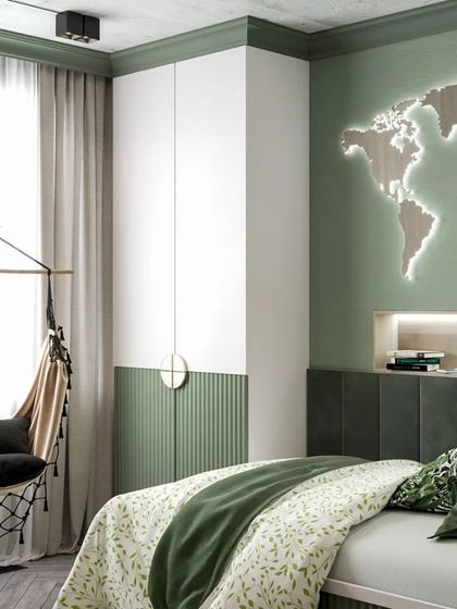 A cozy corner in a travel-themed room, featuring a hanging macrame chair by the window, a custom bed, and a two-tone wardrobe in green and white.