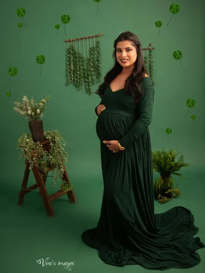 A lucky charm. This portrait in a green gown is adorned with floating four-leaf clovers, symbolizing the blessings and good fortune of this special time.