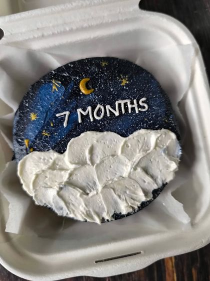 Mark your monthly anniversaries with a special treat. This bento cake features a dreamy night sky design with a crescent moon, stars, and fluffy clouds to celebrate a seven-month milestone.