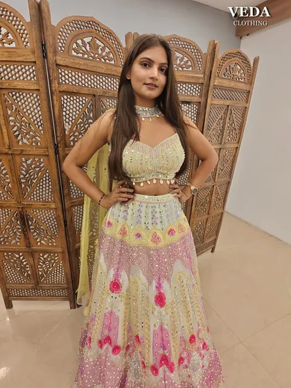 This multi-color lehenga with mirror work is a perfect, vibrant choice for a Mehendi or Haldi function.