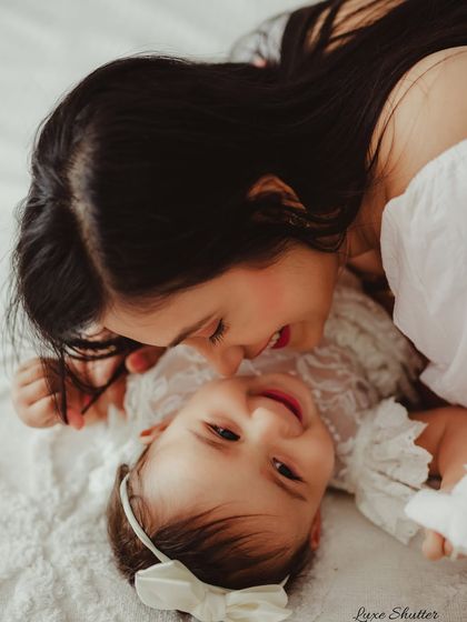 A playful and loving moment between a mother and her baby. This perspective creates a fun and intimate photo full of smiles.