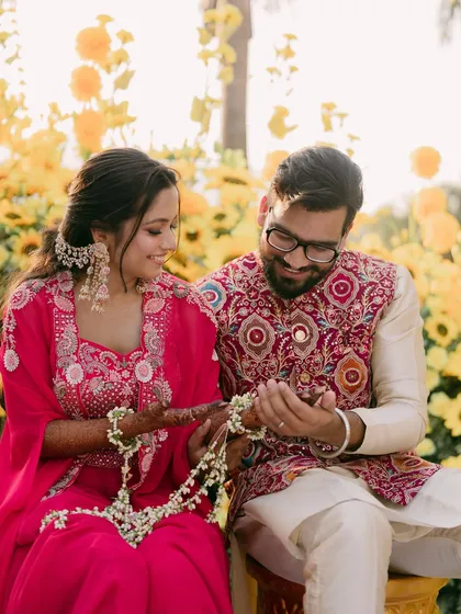 A sweet moment between the couple, surrounded by a field of sunflowers.
