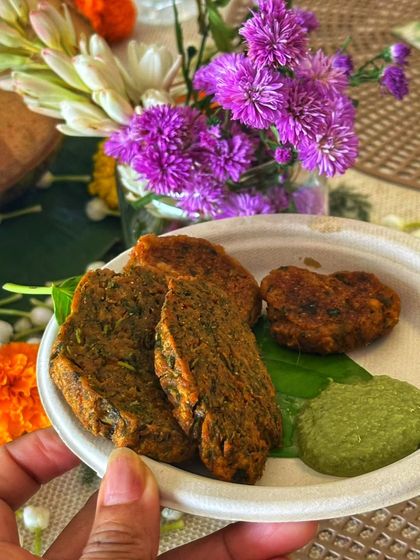 The simple process of making Kothimbir Wadi: roll it, steam it, slice it, and fry it. This snack is a staple for any Maharashtrian celebration, especially during the Ganpati festival.