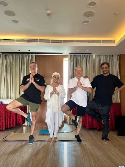 A fun moment after a corporate session, practicing tree pose together. We rise by lifting others.
