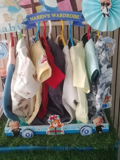 Another angle of the baby wardrobe cart, showcasing the variety of clothes included in the gift.