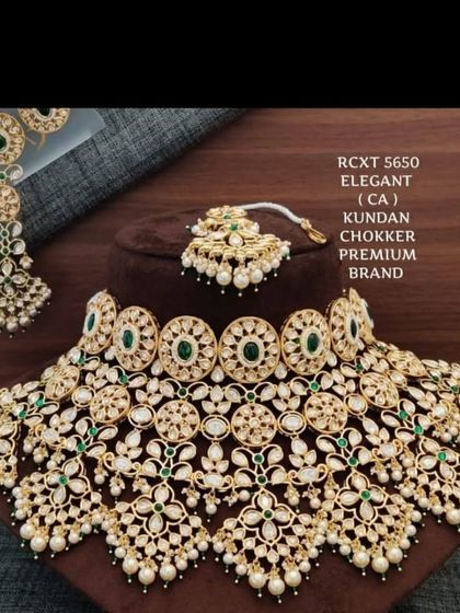 The product shot of a similar grand choker set. This one features green stones and is designed to provide a full, royal look for the bride.