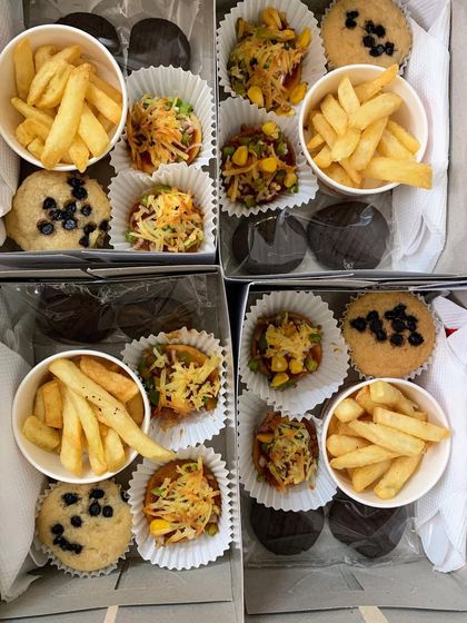 A closer look at my party snack boxes, featuring a delightful mix of choco-chip muffins, french fries, and mini pizzas.