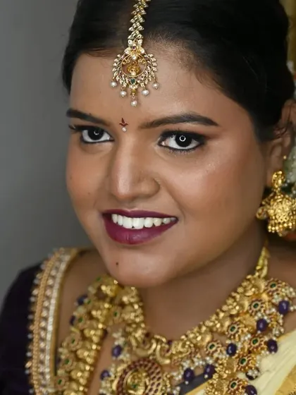 A radiant smile completes the look. My bride Sugandhi looks gorgeous with her bold lip, shimmering gold eyeshadow, and traditional jewellery for her South Indian wedding ceremony.