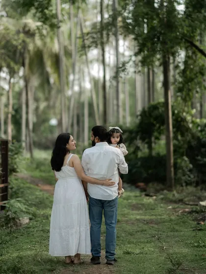 A family's journey is a story told one step at a time. This candid shot captures a family walking together through the woods, a simple moment that speaks volumes about their bond. It’s not about looking at the camera, but about being present with each other.
