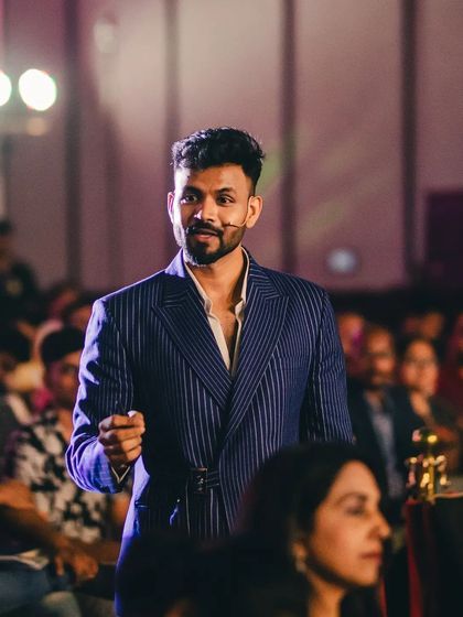 Another angle of our client in his bespoke pinstripe suit. The perfect fit ensures he looks polished and professional from every viewpoint, whether on stage or in a meeting.