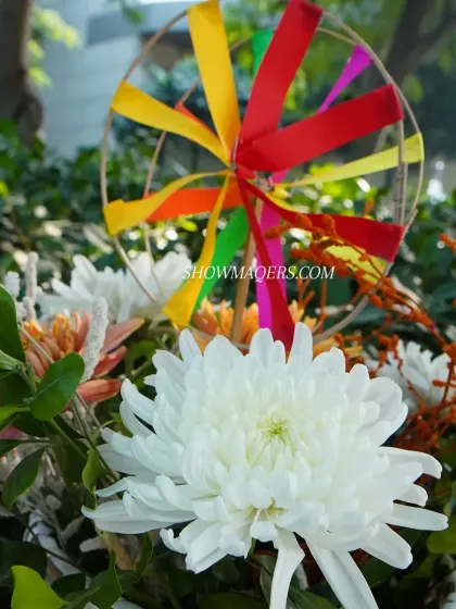 A detailed shot of the floral decor, showing the combination of fresh flowers and whimsical pinwheels.