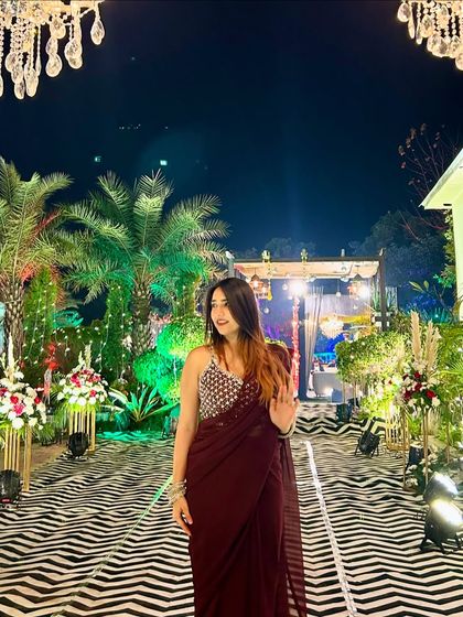 A smiling, happy shot in the maroon saree. This captures the joy of attending a celebration and makes the content feel authentic.