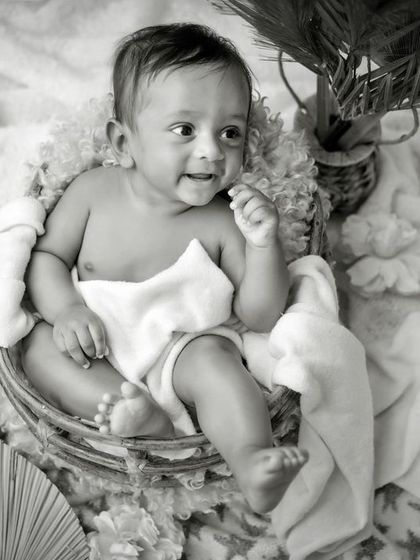 A classic black and white portrait of a happy baby. This timeless shot captures a beautiful, joyful expression.