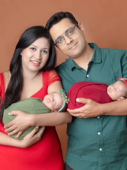 Another beautiful family with their newborn twins, showing how different color choices for outfits can create a whole new look.