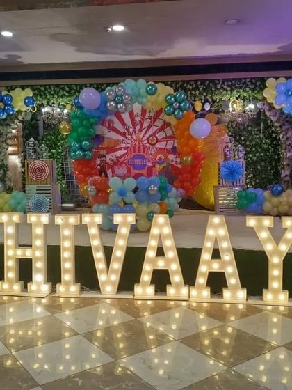 A grand circus-themed first birthday for "Shivaay," featuring huge marquee letters for the name and number, and a colorful stage setup.