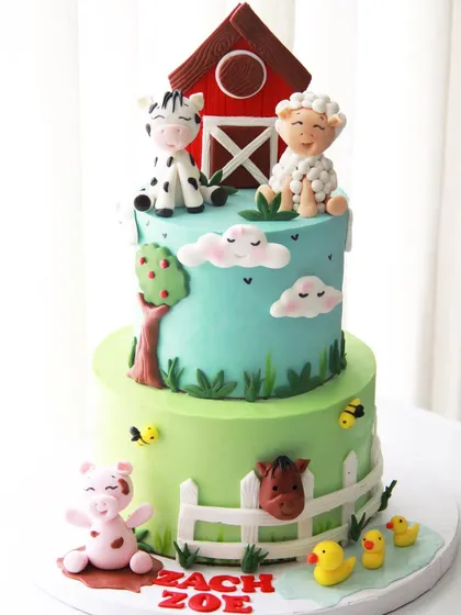 Old MacDonald had a farm, and it was delicious! This two-tiered farm animal cake was made for Zach and Zoe, featuring a barn, pig, cow, sheep, and ducks.