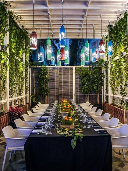 Another view of the elegant outdoor setup for our special dinner, with lush greenery and hanging lanterns creating a magical atmosphere.
