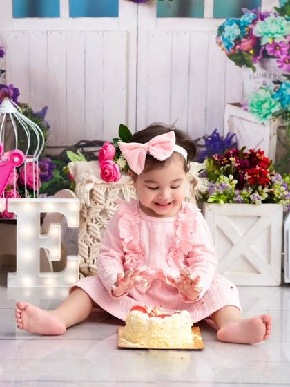 A princess-themed cake smash. The look of delight as she enjoys her first birthday cake is a memory her parents will treasure forever.