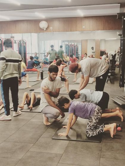 A group of young athletes working on core and flexibility exercises. Building a strong foundation at a young age is the key to a long and healthy athletic career.
