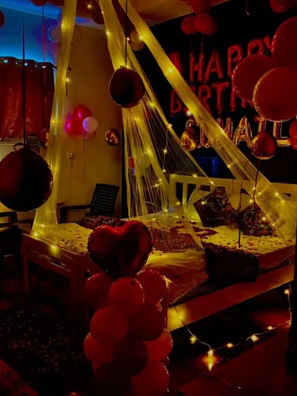 A darker, more intimate shot of a similar room setup. The fairy lights on the canopy provide most of the light, creating a very romantic and moody atmosphere.
