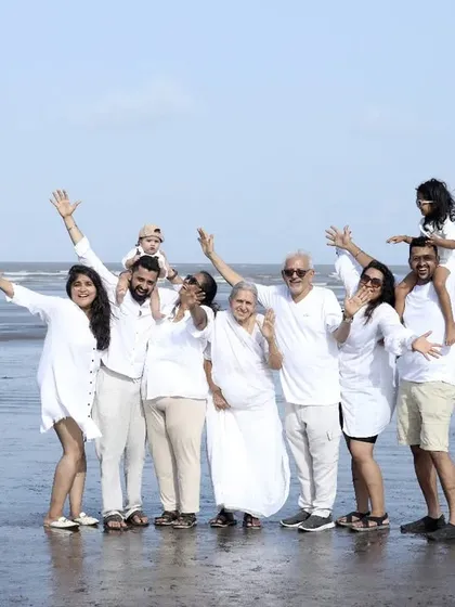 We specialize in capturing the entire 'khandaan'. This outdoor beach session shows a multi-generational family portrait, ensuring that grandparents, parents, and children all share in a beautiful, coordinated memory.
