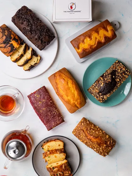 We've perfected the art of the dry cake. This assortment shows the variety we offer, from classic marble and chocolate chip to fruit-filled and nut-topped loaves. Each one is a simple indulgence.