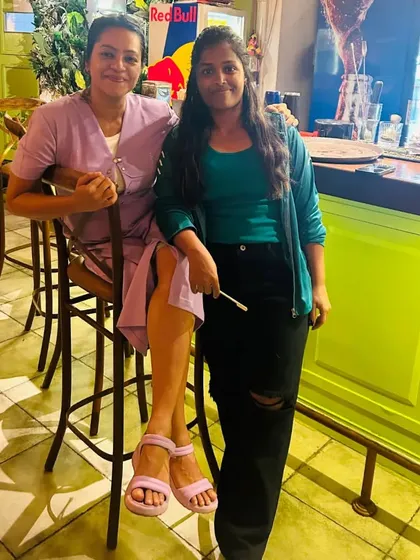 Relaxing with a friend from my dance crew at a local restaurant. These moments of friendship and connection are what fuel my energetic performances.