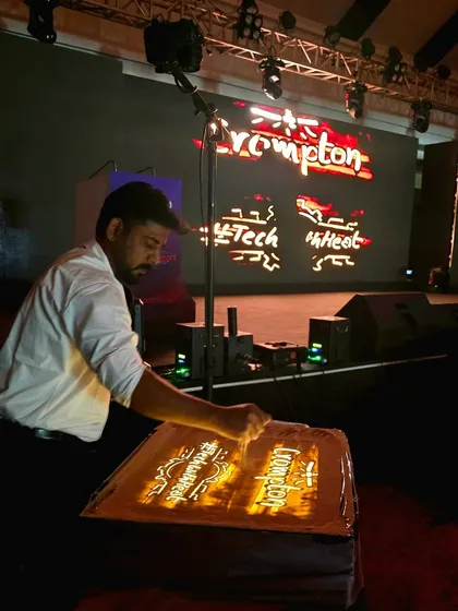 Here I am, live on stage, performing for a major corporate event hosted by Crompton. The art comes to life on the lightbox and is projected onto a large screen, ensuring every person in the audience experiences the magic.