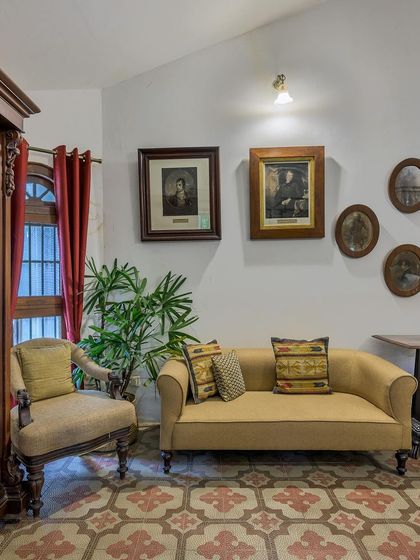A cozy seating area in the Heritage Villa, with vintage portraits and antique furniture creating a sense of history.