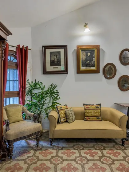 The suites are decorated with authentic details, like these patterned floor tiles and vintage portraits, that honor the history of the property.