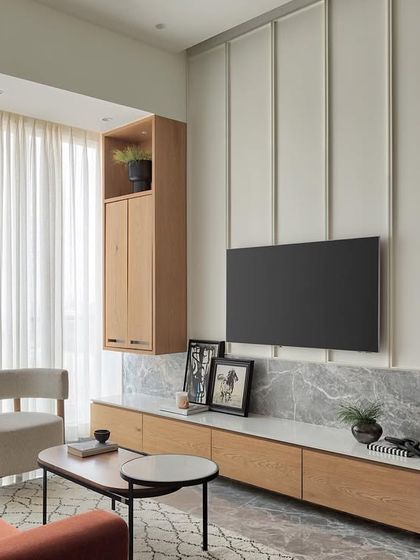 This living room in Apartment 1101 exudes modern elegance with its well-balanced proportions and a pop of color from the rust sofa. The space is designed to be an airy haven of style and comfort.