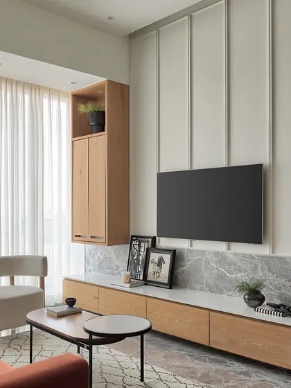 This living room in Apartment 1101 exudes modern elegance with its well-balanced proportions and a pop of color from the rust sofa. The space is designed to be an airy haven of style and comfort.