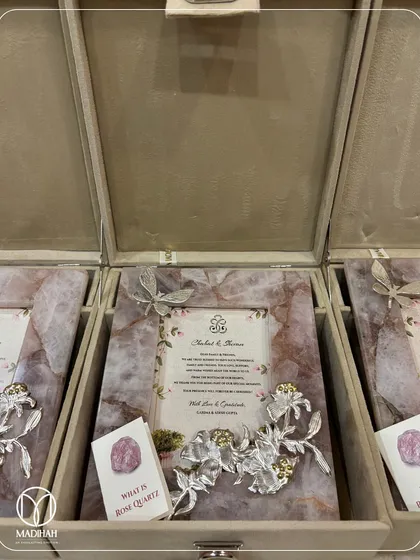 Another view of the rose quartz frames being packed. Each frame is adorned with a sculpted silver butterfly or dragonfly, symbolizing transformation and joy.