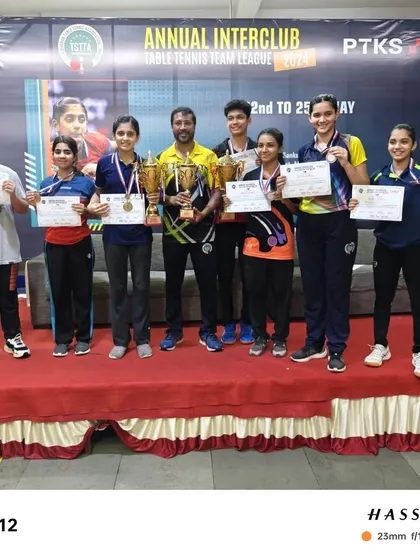 The full lineup of our champions and their coaches on the podium. Success in table tennis is a team effort, and we celebrate it together.