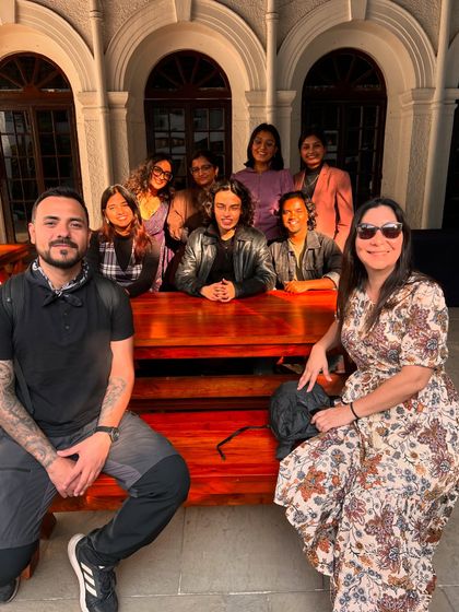 Mentors and participants from the 'Verse and Voice' workshop posing together. We foster a close-knit environment where mentors and students build lasting connections.