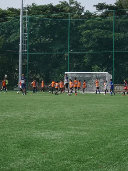 Young players in our U12 and U14 trials participate in a drill near the goal, learning positioning and movement.