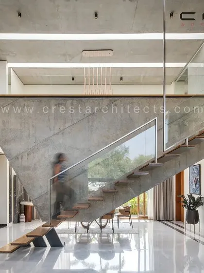 We treat functional elements as sculptural art. This unique staircase in The Quarry House is cantilevered from a suspended concrete wall, creating a gravity-defying centerpiece that is both a passage and a statement of structural innovation.