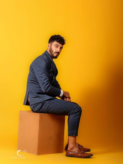 A profile view that offers a different perspective. The simple composition and strong color make this a clean and impactful male portrait.